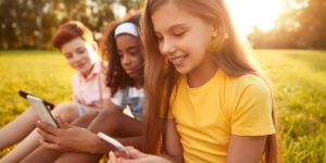 image of kids playing with phone