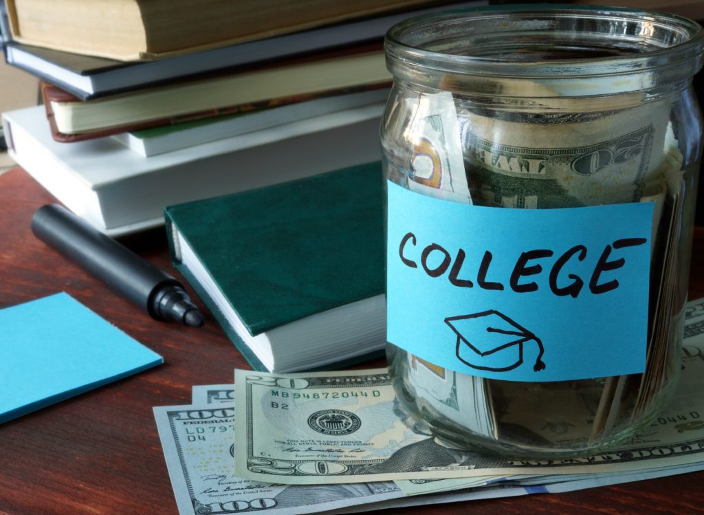 image of jar containing dollar bills saved for college