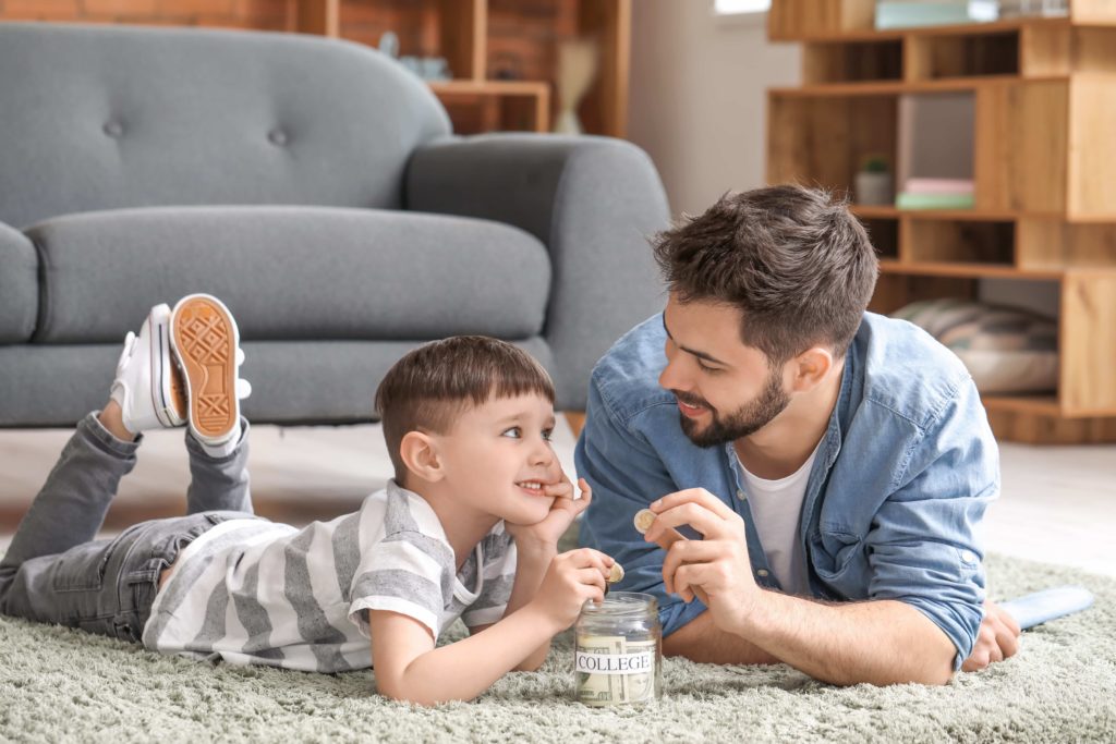 Image of Little boy and father with savings